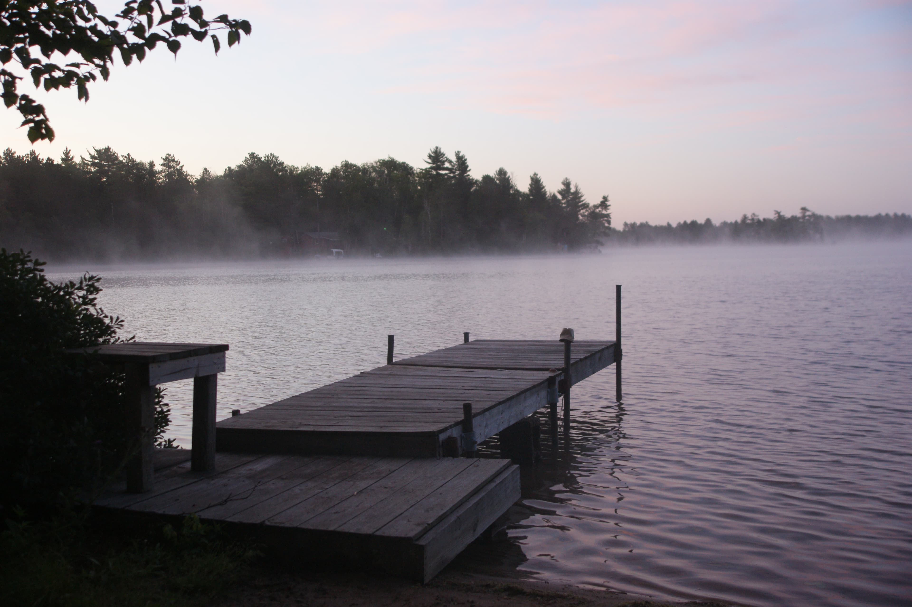 Misty lake dock at dawn